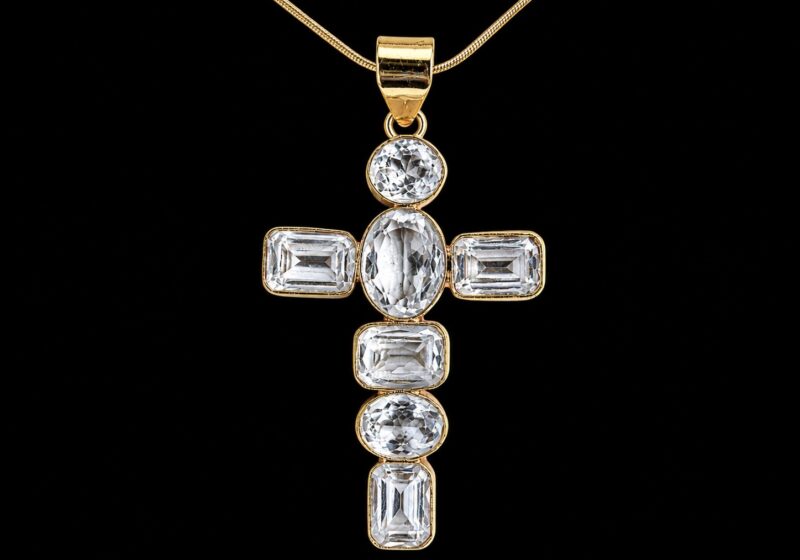 A Gold Plated Cross Pendant With Facetted Rock Crystal Circular,Oval, And Rectangular Cabochons, Each Set In A Gold Plated Frame ,On A Gold Plated Chain Necklace