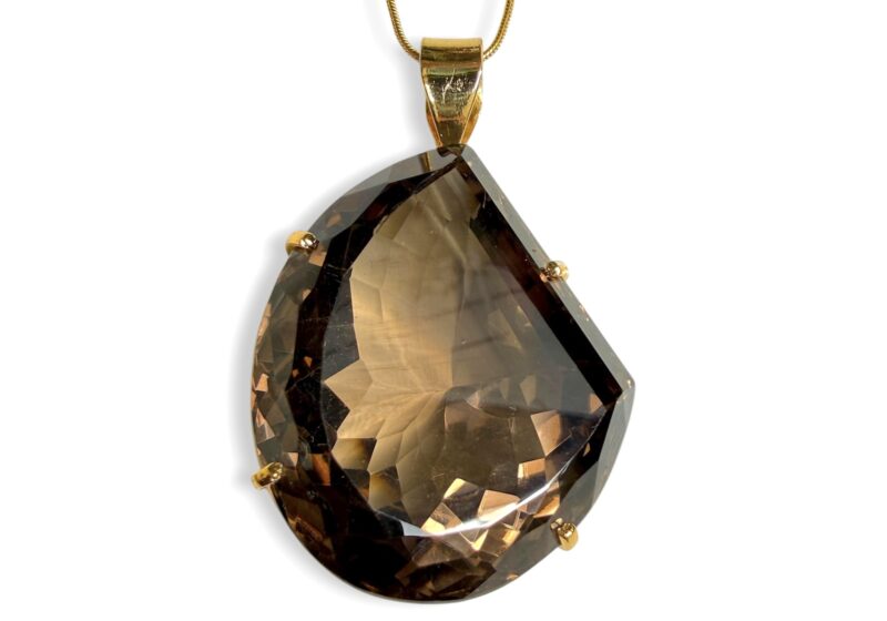 A Large Facetted Smoky Quartz Pear Shaped Pendant, On A Gold Plated Snake Chain Necklace.