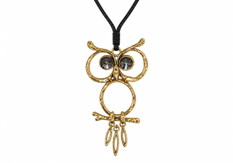 A Golden Metal Pendant Of An Owl With Black Faceted Glass Eyes.