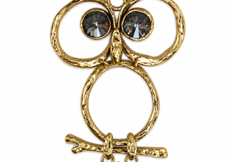A Golden Metal Pendant Of An Owl With Black Faceted Glass Eyes.