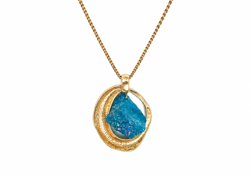 A Long Golden Metal Necklace With An Iridescent Blue Glass Pendant.