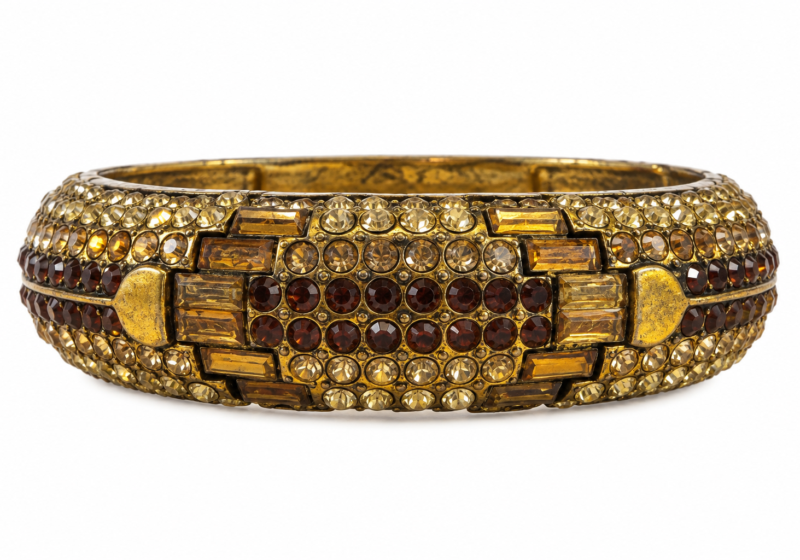 A Golden Metal Hinged Bangle Decorated With Multicoloured Faceted Glass Cabochons.