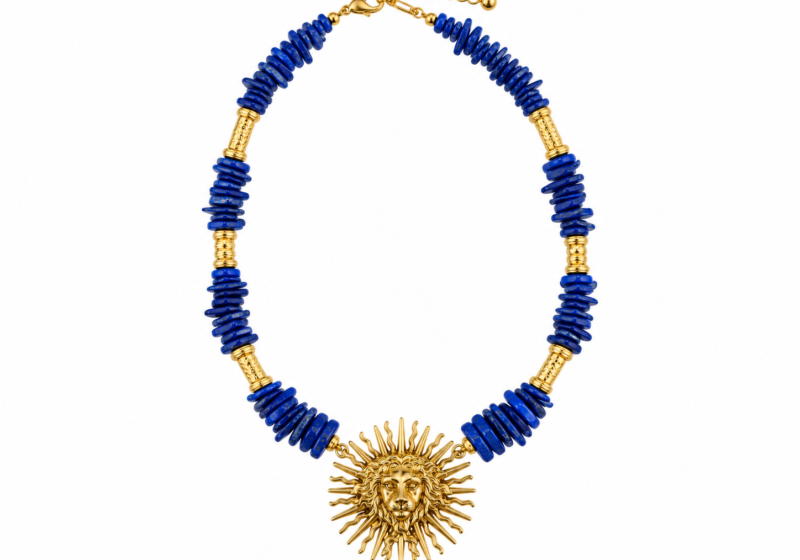 A Long Necklace Of Lapis Lazuli Small Nuggets And Golden Metal Tubular Bands, With A Golden Metal Sun Pendant With A Face In The Centre.
