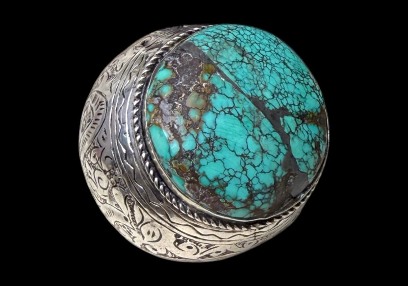 A Large Late Nineteenth Century Afghan Silver Wide Patterned Band Ring Inlaid With A Large Circular Turquoise Cabochon.